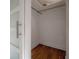 Walk-in closet featuring wood floors, white walls, and modern doors at 7006 N Duncan Ave, Tampa, FL 33604