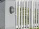 Close up of a white picket fence with a modern outdoor light fixture at 7006 N Duncan Ave, Tampa, FL 33604