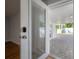 Modern front door with glass and an electronic lock leading to a paved patio at 7006 N Duncan Ave, Tampa, FL 33604