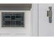 Close-up of a decorative front door with stained glass and a modern exterior light fixture at 7006 N Duncan Ave, Tampa, FL 33604