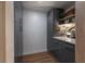 Hallway featuring gray cabinets and wood floors at 7006 N Duncan Ave, Tampa, FL 33604