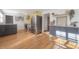 Spacious kitchen with stainless steel appliances, grey cabinets, and hardwood floors at 7006 N Duncan Ave, Tampa, FL 33604
