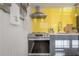 Modern kitchen with stainless steel appliances and yellow tiled backsplash at 7006 N Duncan Ave, Tampa, FL 33604