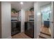 Well-organized laundry area showcasing a washer and dryer, enhanced by wooden cabinets, adding a touch of warmth at 7006 N Duncan Ave, Tampa, FL 33604
