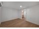 Bright living room featuring wood floors and white walls that creates a modern, minimalist atmosphere at 7006 N Duncan Ave, Tampa, FL 33604