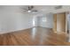 Large, bright, empty living room with wood floors, white walls, and ceiling fan at 7006 N Duncan Ave, Tampa, FL 33604