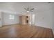 Spacious living room featuring new wood floors, large window, and a ceiling fan at 7006 N Duncan Ave, Tampa, FL 33604