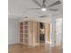 Spacious living room featuring newly constructed shelving and doorway into kitchen at 7006 N Duncan Ave, Tampa, FL 33604