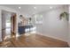 Bright living room with hardwood floors, white walls, and a built-in bar with modern shelving and decor at 7006 N Duncan Ave, Tampa, FL 33604