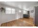 Bright living space with wood floors, white walls, many windows, and grey cabinets at 7006 N Duncan Ave, Tampa, FL 33604