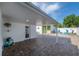 Comfortable covered patio with access to backyard and exterior features at 7006 N Duncan Ave, Tampa, FL 33604