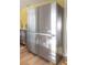 Stainless steel Samsung refrigerator in updated kitchen with subway tile and wood floors at 7006 N Duncan Ave, Tampa, FL 33604