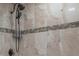 Close-up of shower with rainfall showerhead and tiled accents at 7006 N Duncan Ave, Tampa, FL 33604