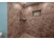 Tiled shower area featuring a showerhead and soap dish, creating a functional and stylish bathing space at 7006 N Duncan Ave, Tampa, FL 33604