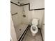 Bathroom featuring shower, toilet, and simple tile flooring and trim at 703 E Hamilton Ave, Tampa, FL 33604