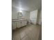 Bathroom featuring a vanity with sink, toilet, and neutral tile flooring at 703 E Hamilton Ave, Tampa, FL 33604