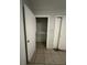 A bedroom closet with shelving and storage, complemented by tile flooring at 703 E Hamilton Ave, Tampa, FL 33604