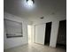 Small bedroom with tile flooring, closet, and natural lighting from the window at 703 E Hamilton Ave, Tampa, FL 33604