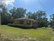 Charming single-story home with a well-manicured lawn and mature trees offering curb appeal at 703 E Hamilton Ave, Tampa, FL 33604