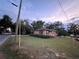 Exterior view of a cozy single-story home featuring a landscaped yard at 703 E Hamilton Ave, Tampa, FL 33604