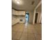 Bright kitchen featuring white cabinets and an electric range oven at 703 E Hamilton Ave, Tampa, FL 33604