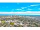 Scenic aerial view captures the cityscape in the distance, surrounded by lush greenery and blue skies with fluffy clouds at 7081 Lafayette N, Pinellas Park, FL 33781
