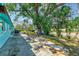 Spacious backyard featuring a patio, mature trees, and lush landscaping at 7081 Lafayette N, Pinellas Park, FL 33781