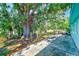 Expansive backyard with lush trees and a patio area perfect for outdoor relaxation at 7081 Lafayette N, Pinellas Park, FL 33781