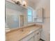 Bathroom with a large mirror, vanity, and shower with glass doors at 7081 Lafayette N, Pinellas Park, FL 33781