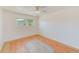 Sunny bedroom with a ceiling fan, wood-look flooring, and ample natural light at 7081 Lafayette N, Pinellas Park, FL 33781
