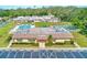 Exterior view of community center, showcasing pool, shuffleboard courts, and well-maintained grounds at 7081 Lafayette N, Pinellas Park, FL 33781