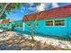 Colorful home exterior featuring large windows, red roof, and a walkway at 7081 Lafayette N, Pinellas Park, FL 33781