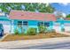 Home exterior featuring bright paint, red roof, and low-maintenance landscaping at 7081 Lafayette N, Pinellas Park, FL 33781
