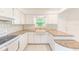 Bright kitchen featuring white cabinets, modern appliances, stylish countertops, and tiled backsplash at 7081 Lafayette N, Pinellas Park, FL 33781