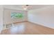 This bright living room has wood floors, a ceiling fan, and a view of the outside at 7081 Lafayette N, Pinellas Park, FL 33781