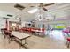 Spacious meeting room with tables, chairs, library, and access to outdoor views, perfect for community events at 7081 Lafayette N, Pinellas Park, FL 33781