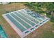 Overhead shot of shuffleboard courts lined by benches, nestled within a manicured lawn and mature trees at 7081 Lafayette N, Pinellas Park, FL 33781