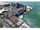 Aerial view of waterfront condos offering tennis courts, pool, and beach access at 7100 Sunset Way # 303, St Pete Beach, FL 33706