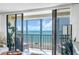 Bright condo balcony view with sliding glass doors overlooking the ocean at 7100 Sunset Way # 303, St Pete Beach, FL 33706