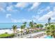 Aerial view of the beach area featuring palm trees and a swimming pool at 7100 Sunset Way # 303, St Pete Beach, FL 33706