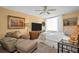 Bright bedroom featuring a seating area, TV, and neutral accents at 7100 Sunset Way # 303, St Pete Beach, FL 33706