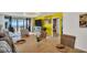 Bright dining room featuring wicker chairs, modern chandelier, and views of the ocean at 7100 Sunset Way # 303, St Pete Beach, FL 33706