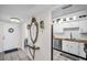 Inviting entryway featuring tile floors, mirrored console, decorative accents, and a view into the adjacent kitchen at 7100 Sunset Way # 303, St Pete Beach, FL 33706