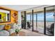 Living room area featuring large glass doors, ocean views, and comfortable seating at 7100 Sunset Way # 303, St Pete Beach, FL 33706