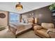 Bright main bedroom featuring a chandelier, ocean view, and stylish decor at 7100 Sunset Way # 303, St Pete Beach, FL 33706