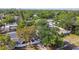 A beautiful white fenced property surrounded by large trees offering shade, privacy, and curb appeal at 7210 8Th N Ave, St Petersburg, FL 33710
