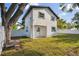Fenced backyard offers privacy, complemented by a well-kept lawn and the home's exterior at 7210 8Th N Ave, St Petersburg, FL 33710