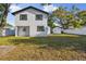 Spacious, fenced backyard with a well-maintained lawn and the home's back exterior at 7210 8Th N Ave, St Petersburg, FL 33710