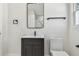 Bathroom featuring a dark vanity, black fixtures, a square mirror, and a modern toilet at 7210 8Th N Ave, St Petersburg, FL 33710