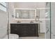 Bathroom with double vanity, an illuminated mirror, and a glass-enclosed shower at 7210 8Th N Ave, St Petersburg, FL 33710